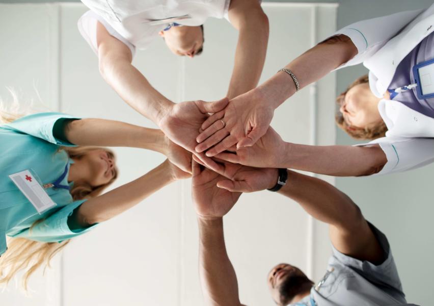 Professionnels de santé unissant leurs mains, pluridisciplinarité
